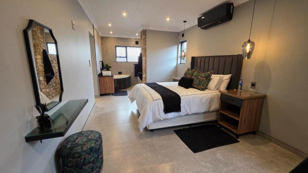 a bedroom with a bed and a television in it at Cranes Nest Guest House in Pretoria