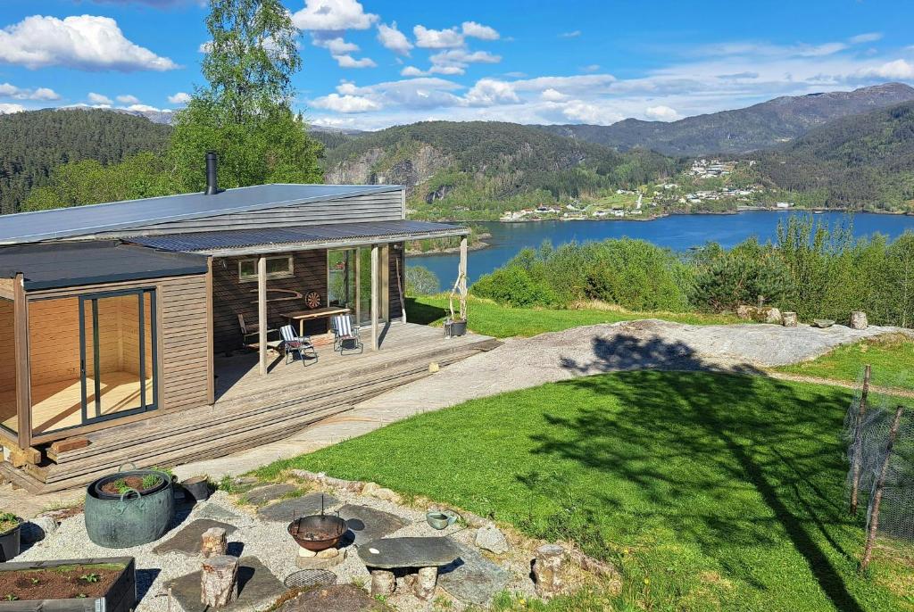 a small house with a view of a lake at Self-Built Cabin With Views Over Leirvik in Leirvik