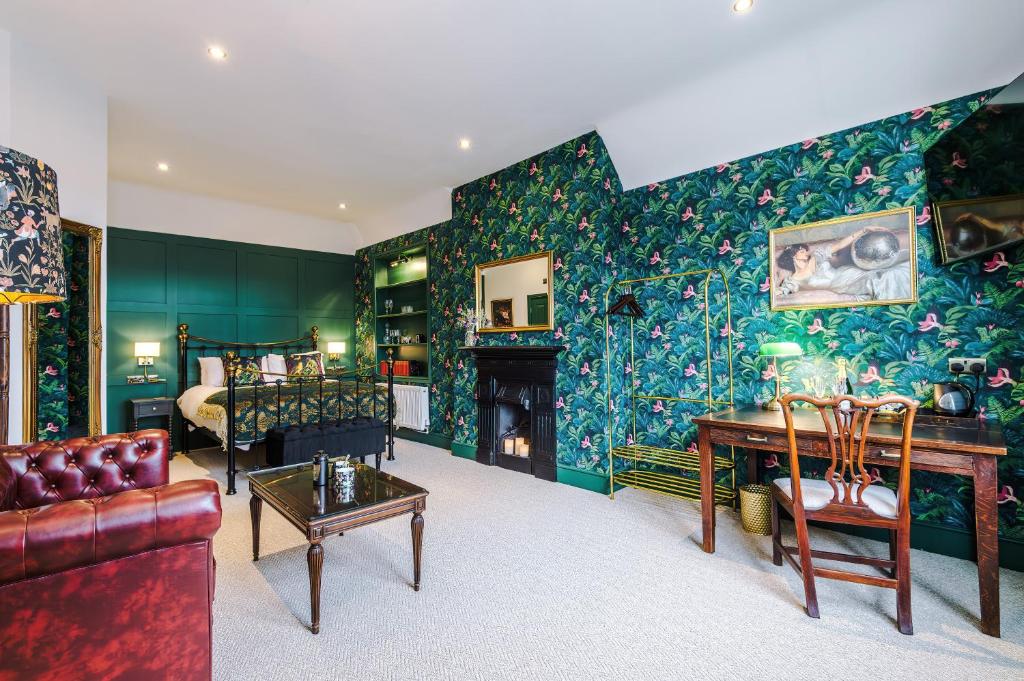 a living room with green walls and a fireplace at Godstall Lane Boutique Accommodation in Chester