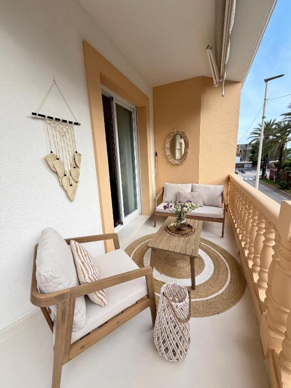 a balcony with two chairs and a table at Moraira Castle Boutique Apartment in Moraira