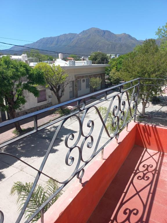 a balcony with a railing with mountains in the background at Hotel Praise in Capilla del Monte