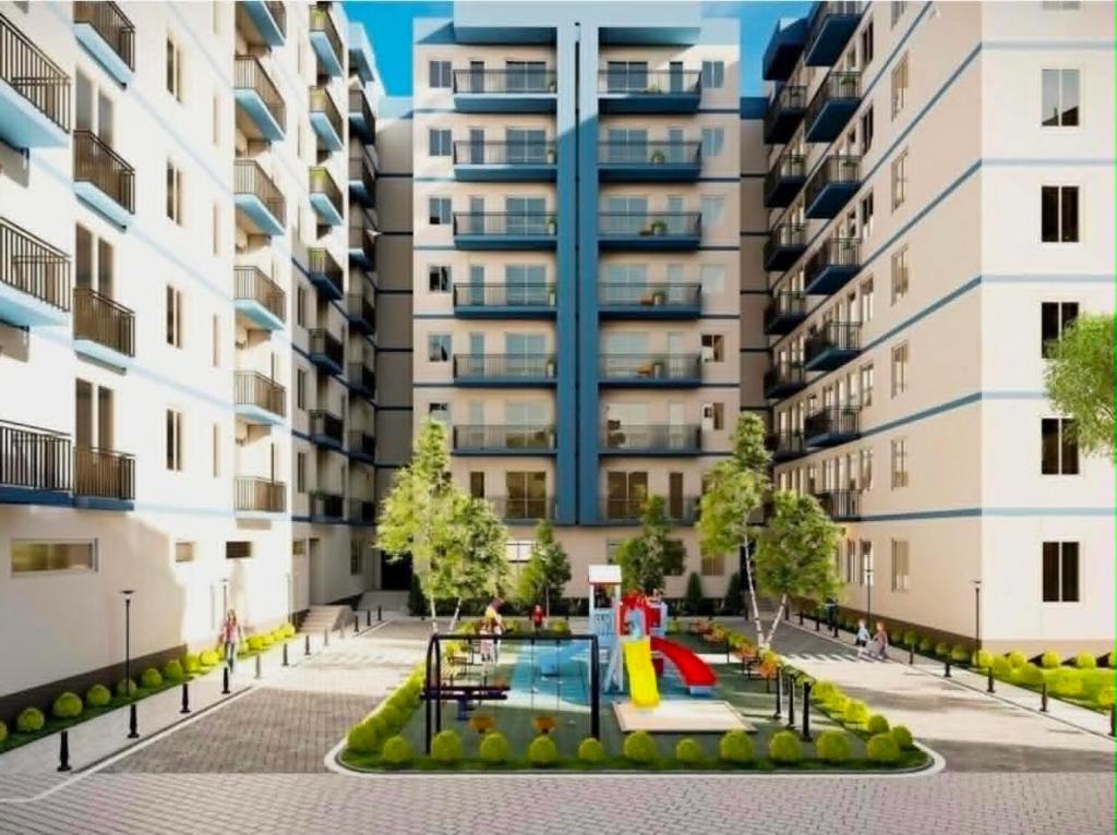 an apartment building with a pool and a playground at Gori Palace in Gori