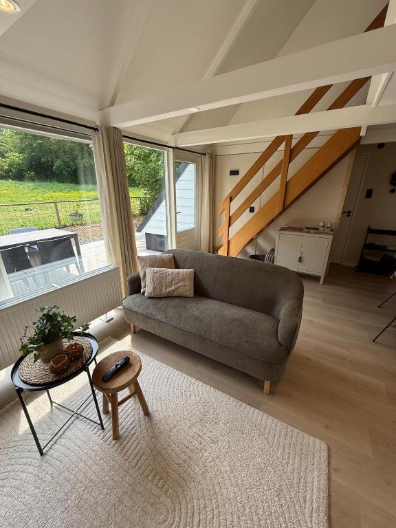 a living room with a couch and a table at Vakantiewoning Asteri's Home in Simpelveld