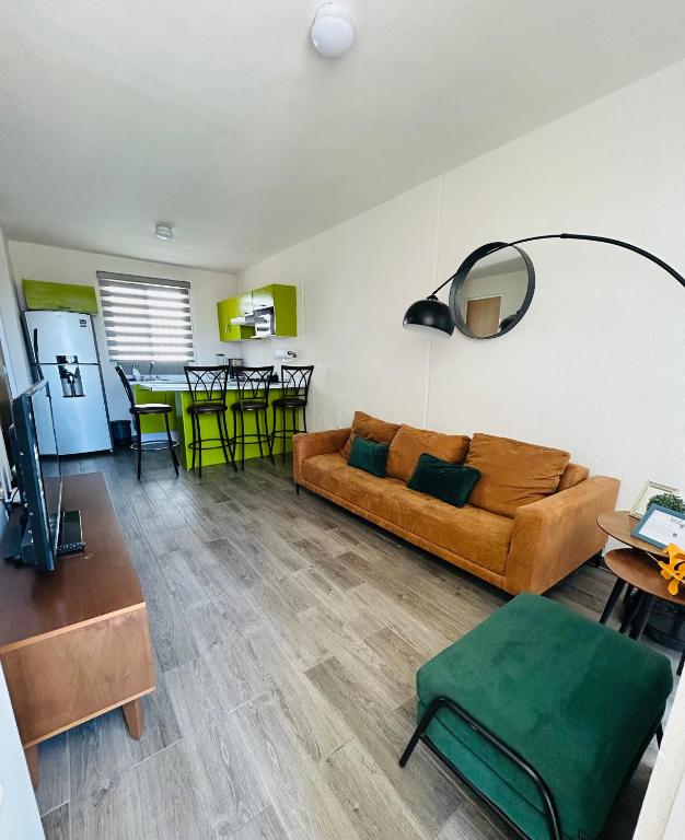 a living room with a couch and a table at Camino antiguo a Tesistan in Zapopan