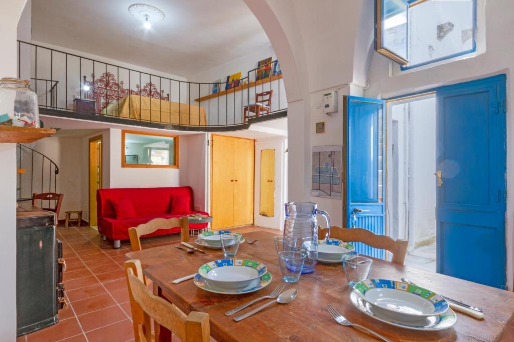 a dining room with a wooden table and chairs at GuestHost - Casa Paola in Cannole