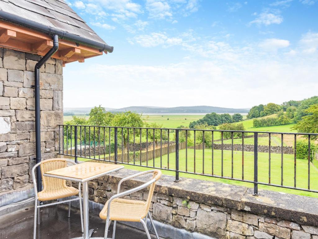 a table and chairs on a balcony with a view at Kent View Apartment in Lindale