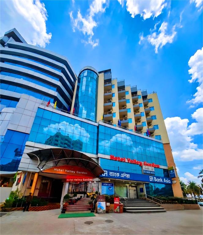 a large building with glass windows on the side of it at Hotel Valley Garden - Sylhet in Sylhet