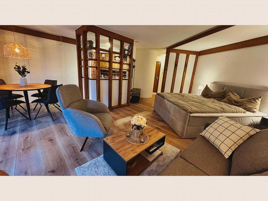 a living room with a bed and a table at Apartment Am Dürrbach 4-413 by Interhome in Engelberg