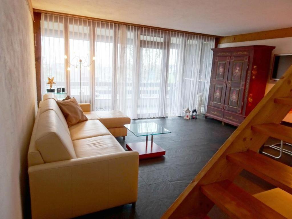 a living room with a couch and a table at Apartment Am Dürrbach 5-545 by Interhome in Engelberg