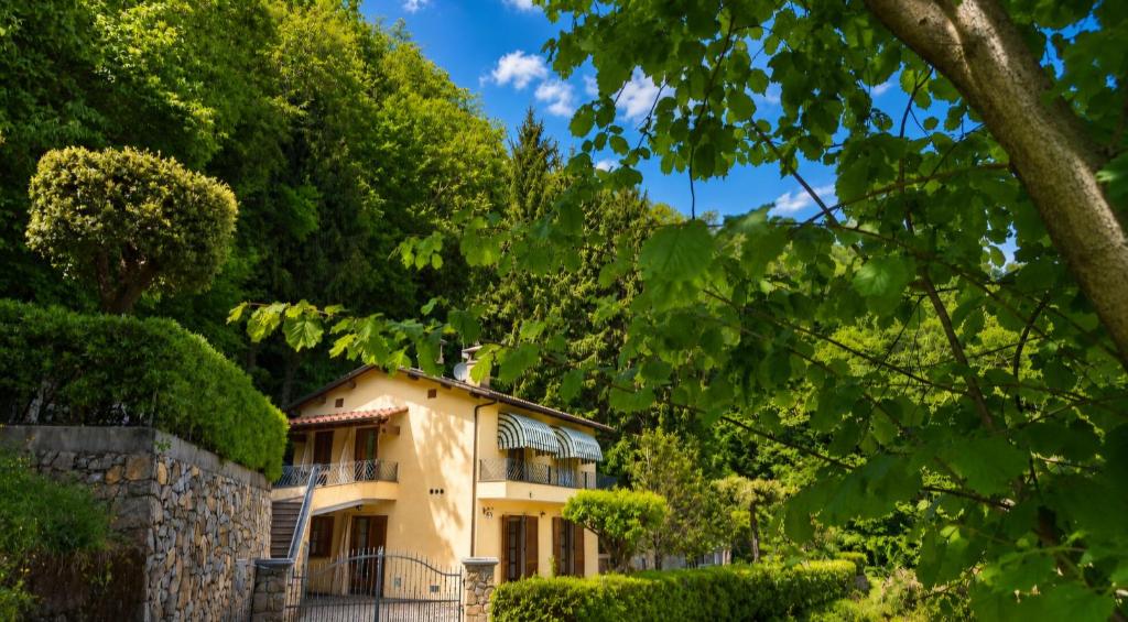 a yellow building with trees in front of it at Villa Marisa in Stazzema