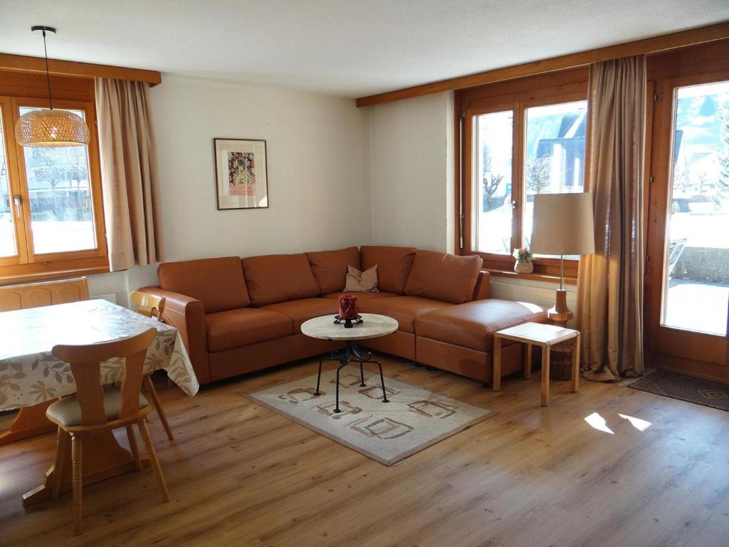 a living room with a couch and a table at Apartment Blumenweg 6 by Interhome in Engelberg