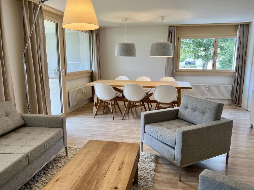 a living room with a dining room table and chairs at Apartment Alte Gasse 9 by Interhome in Engelberg