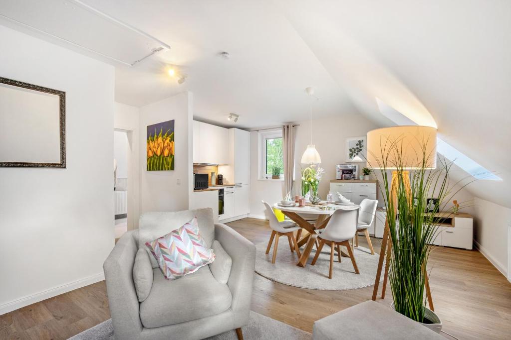 a living room and dining room with a table and chairs at Ferienwohnung Nordic Stay Bäk in Bäk