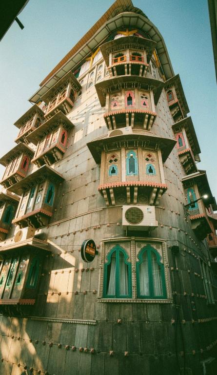 a tall building with windows and balconies on it at AAJ HAVELI - Pichola Lake Facing Hotel in Udaipur