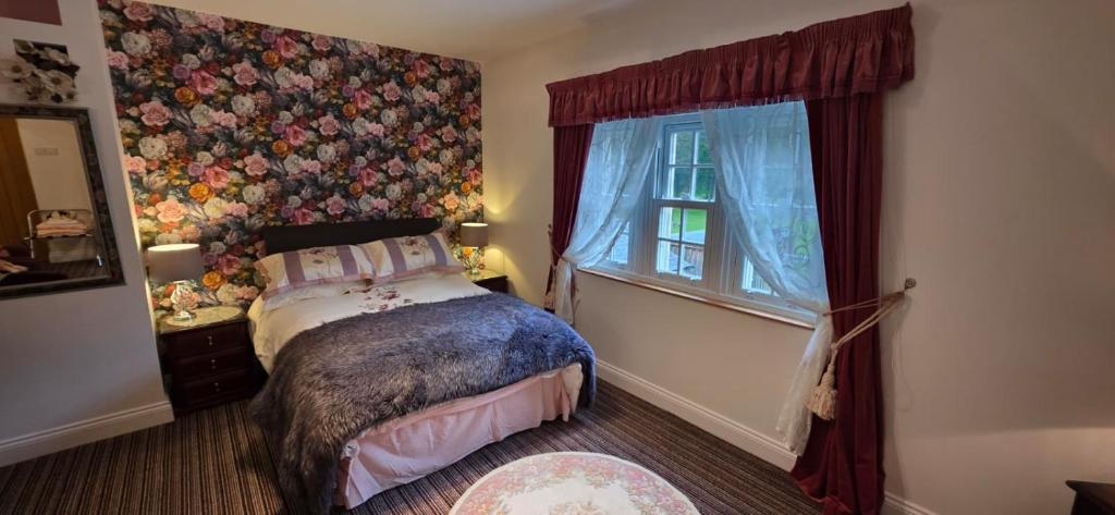 a bedroom with a bed and a window at Island House in Lanercost
