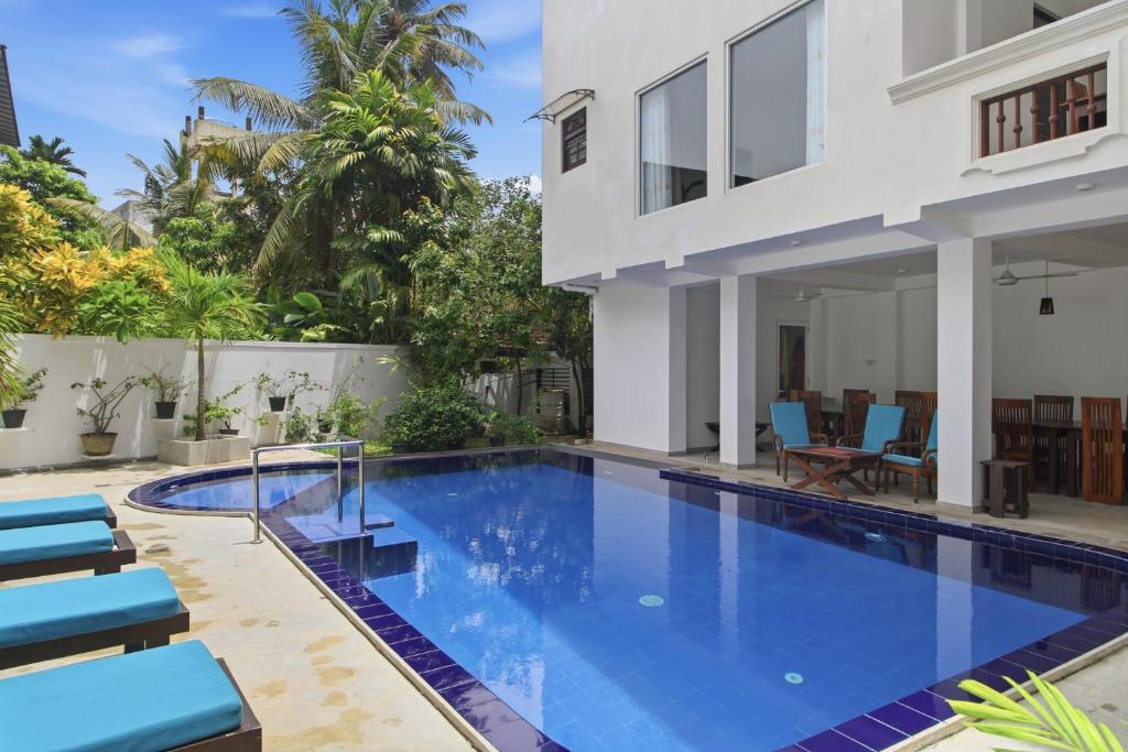 a swimming pool in the backyard of a villa at Mihira Gedara Apartments in Unawatuna