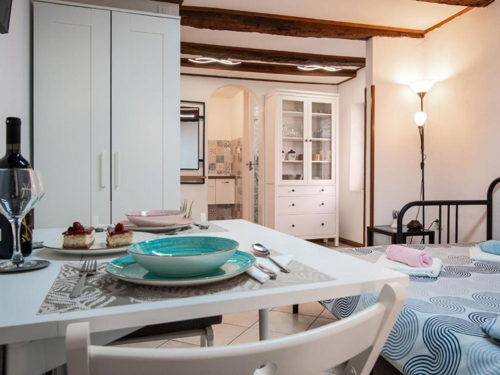 a kitchen and dining room with a table and chairs at Studio Piccolo Mondo by Interhome in Lovran