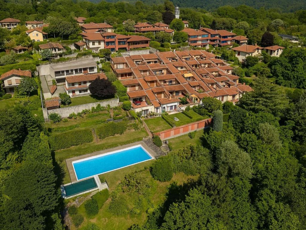 an aerial view of a house with a swimming pool at Apartment Lake & Pool by Interhome in Leggiuno
