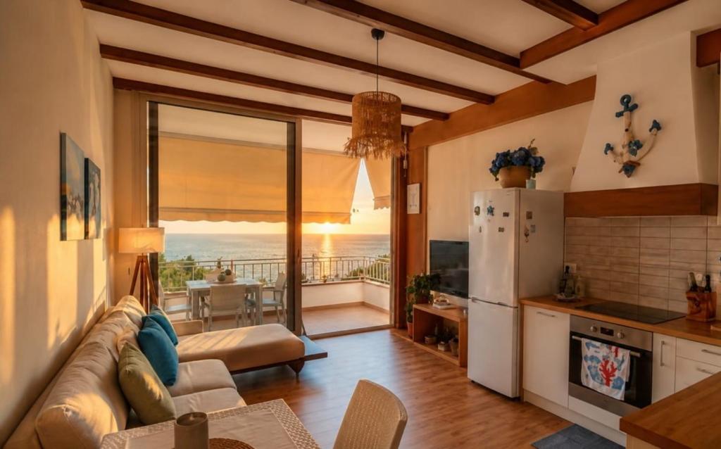 a kitchen and living room with a couch and a refrigerator at DeJon Apartment in Gjilek