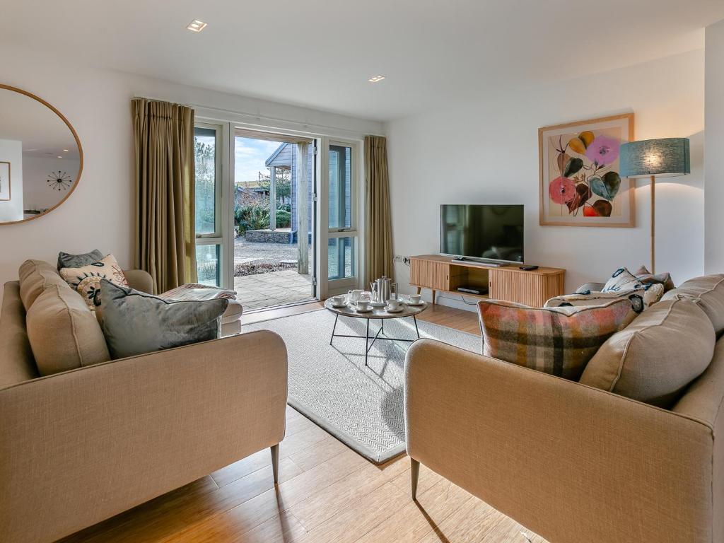 a living room with two couches and a television at Lodge 53 Una in Carbis Bay