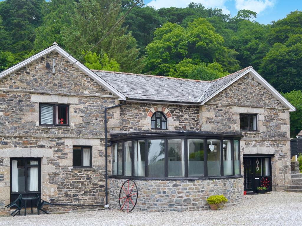 an old stone house with a large window at Gamekeepers Apt - Cv20 in Liskeard