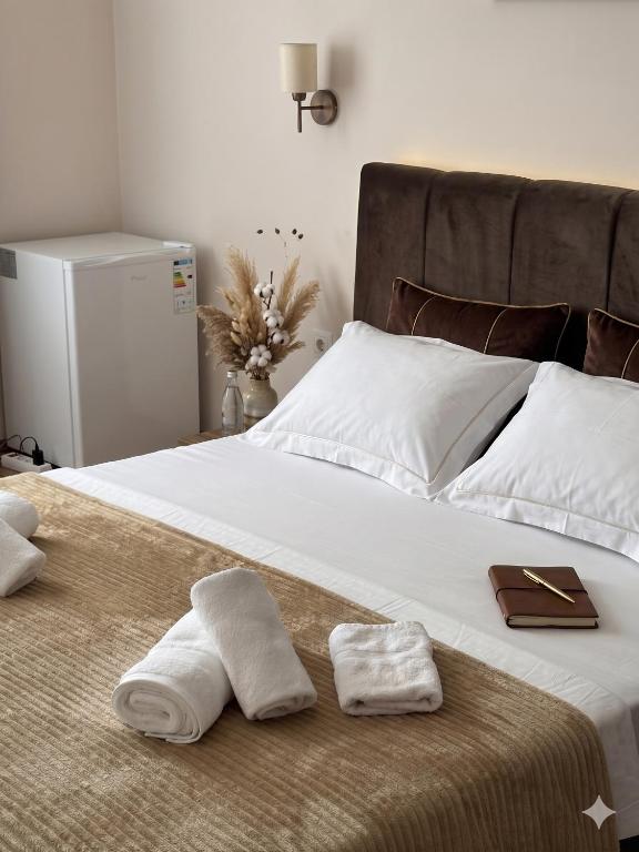 a large bed with two towels on top of it at Guest House Kobuleti 516 in Kobuleti