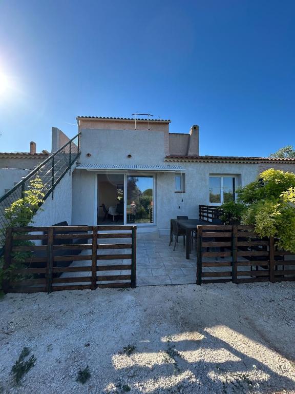 a house with a fence and a table in front of it at F2 Ismaël in Solliès-Pont