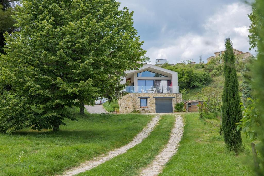 a house on a hill with a dirt road at Le Lavoir De Gras - Chambre d'hôte in Gras