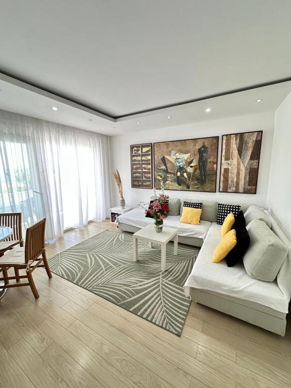 a living room with a couch and a table at Apartments Karmen Maria in Novigrad Istria