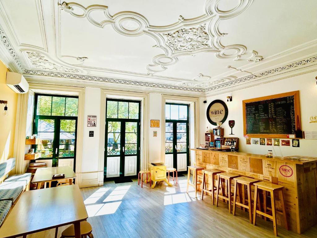 a room with tables and chairs and a ceiling at Porto Wine Hostel in Porto