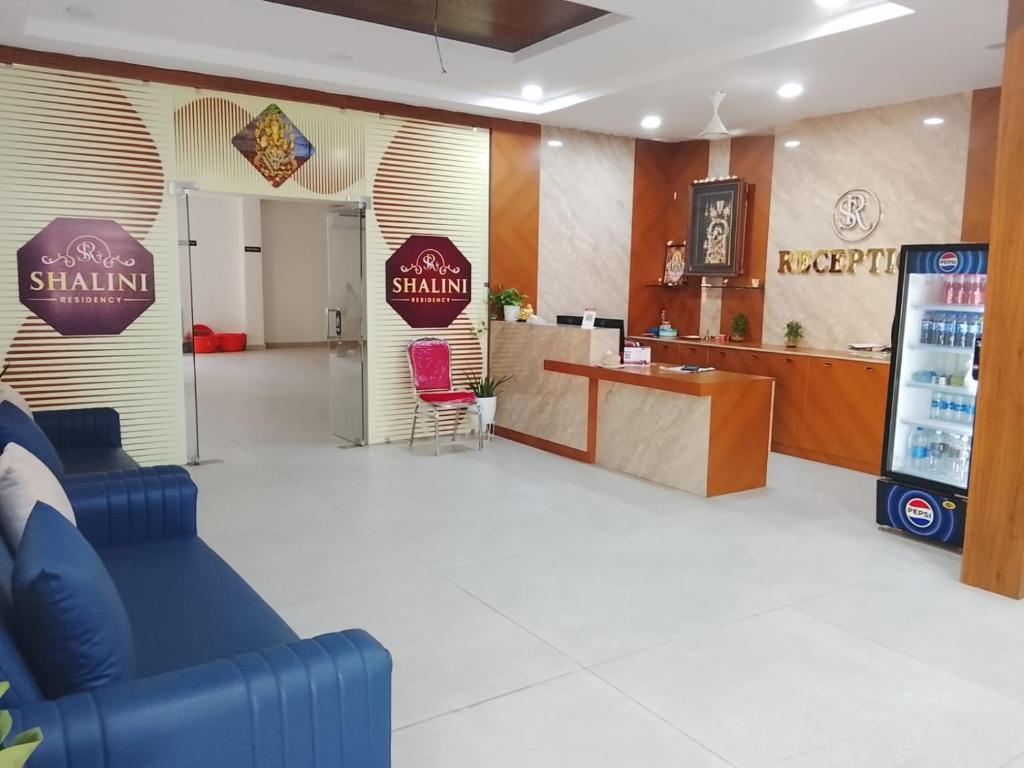 a starlin restaurant with a counter and a bar at Shalini Residency in Nalgonda