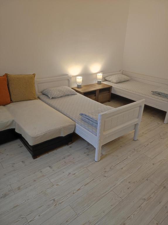 a room with two beds and two tables and lamps at Chostello Ecomis Clasik in Sibiu