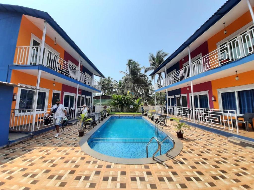 a view of the courtyard of a hotel with a swimming pool at Sabbia Rossa Beach Resort in Arambol
