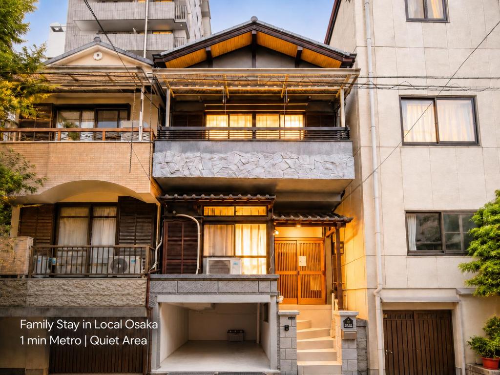 an apartment building with a porch and a balcony at New Entire Family House 1 Min to Metro Umeda Direct in Osaka