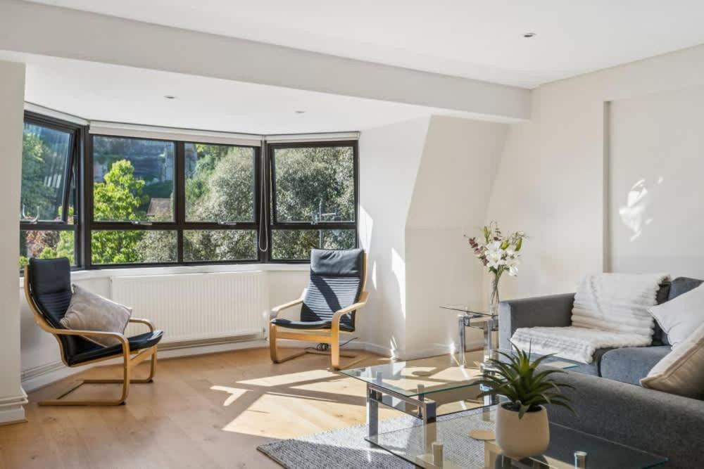 a living room with a couch and chairs and a table at Windsor Castle Views - Spacious Flat - By Tempstay in Windsor