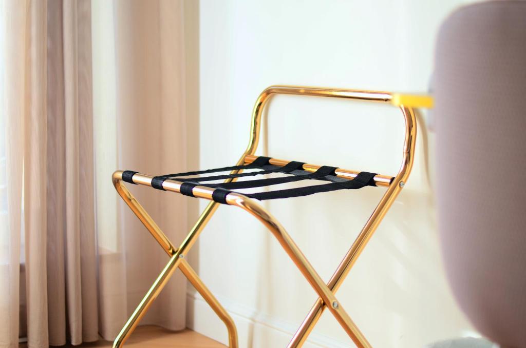 a chair sitting in front of a window at Hôtel le XIX in Béziers