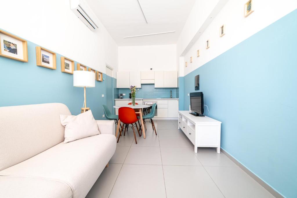 a living room with a couch and a table at Maréa apartments - Sul mare 2 in Alba Adriatica