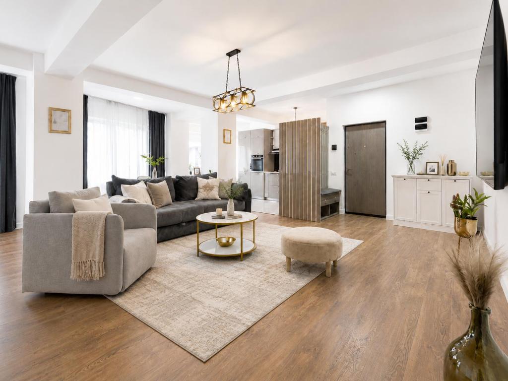 a living room with a couch and a table at Pop Up Aparthotel in Bucharest
