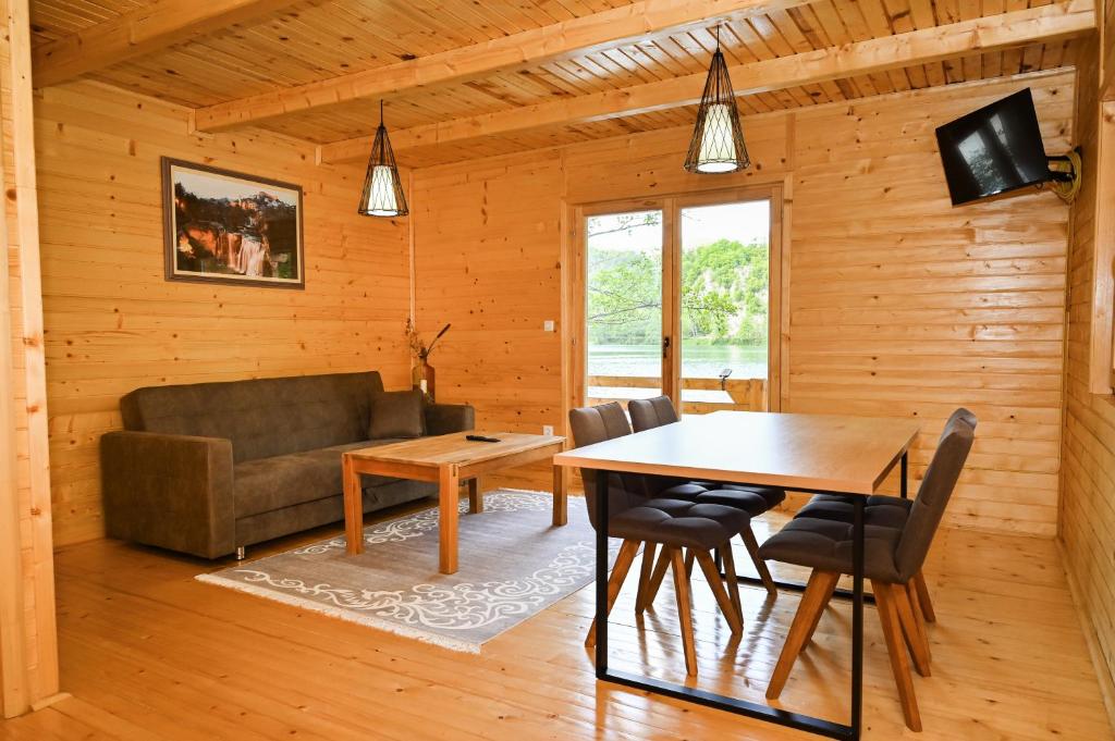 a living room with a table and a couch at Cottage Sunshine in Jajce