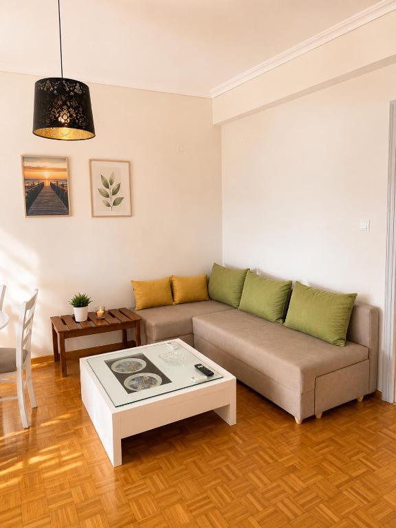 a living room with a couch and a coffee table at Nickolas Sea View Apartment in Paleo Tsifliki