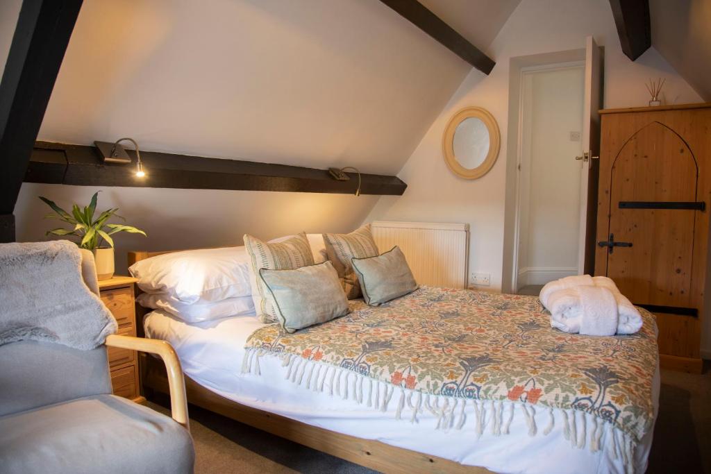 a bedroom with a bed with a dog laying on it at The Tollgate Inn in Bradford on Avon