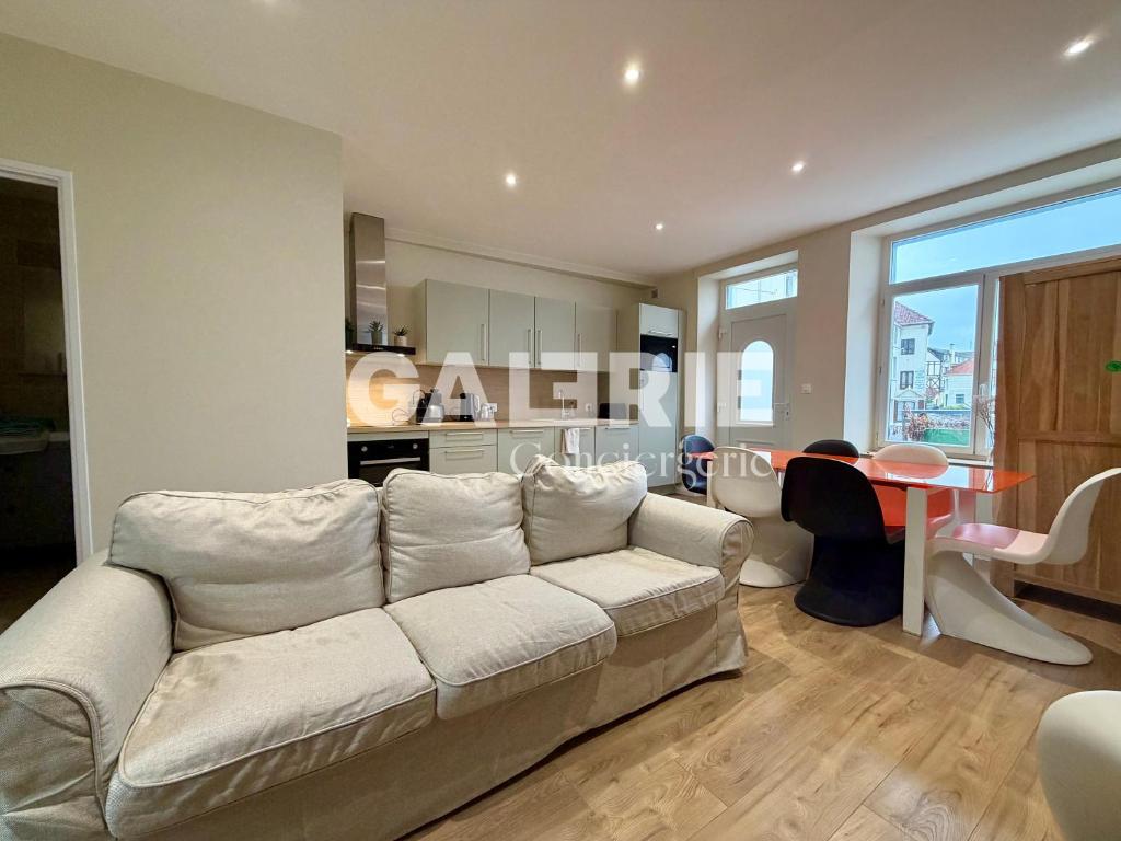 a living room with a white couch and a table at GC - Le Caps des Dunes - Centre in Wissant