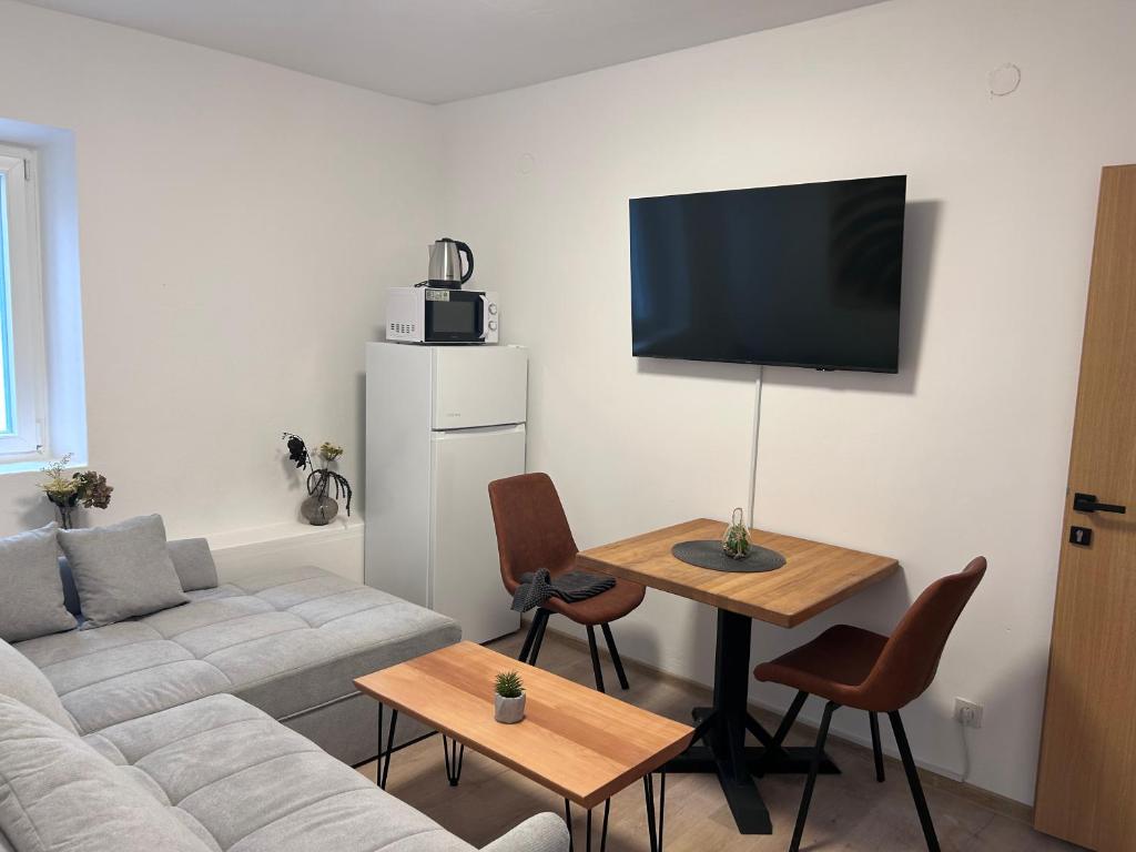 a living room with a couch and a table at Soti Apartments in Kupari