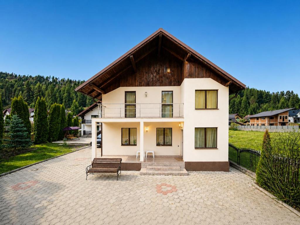 a large white house with a wooden roof at Casa Valeria Voronet in Voronet