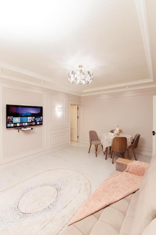 a living room with a couch and a table at Miracle Apartment in Samarkand