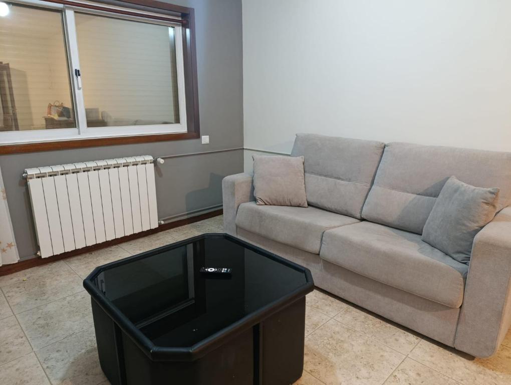 a living room with a couch and a coffee table at Flamant apart in Aguçadoura