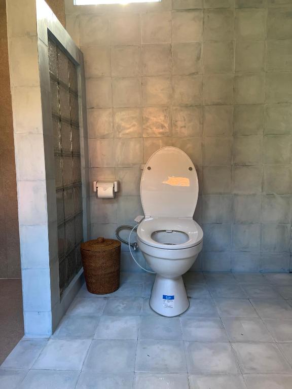 a bathroom with a toilet with the lid up at Green Labak 1 in Silebeng