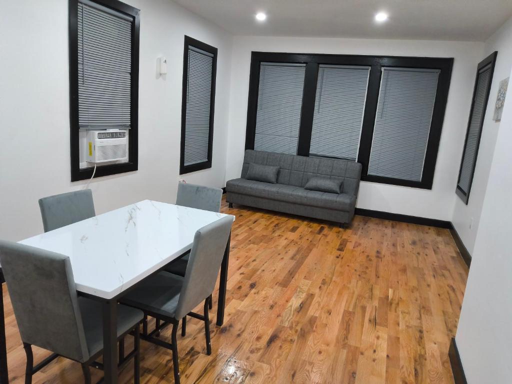 a living room with a table and chairs and a couch at Log Comfort 3 in Irvington
