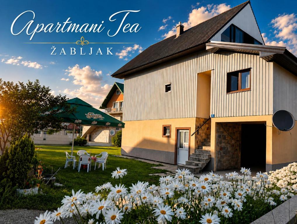 a picture of a house with flowers in the yard at Studio Apartman Tea, Žabljak in Žabljak