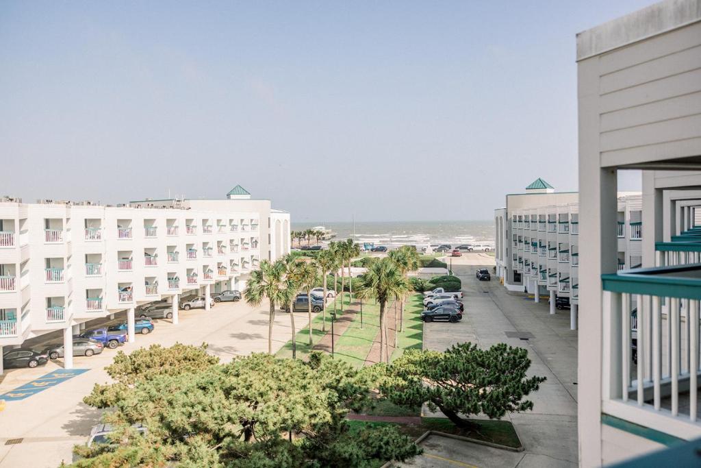 a view of the beach from the balcony of a building at Blue Pearl Beachfront Condo at Casa de Mar in Galveston